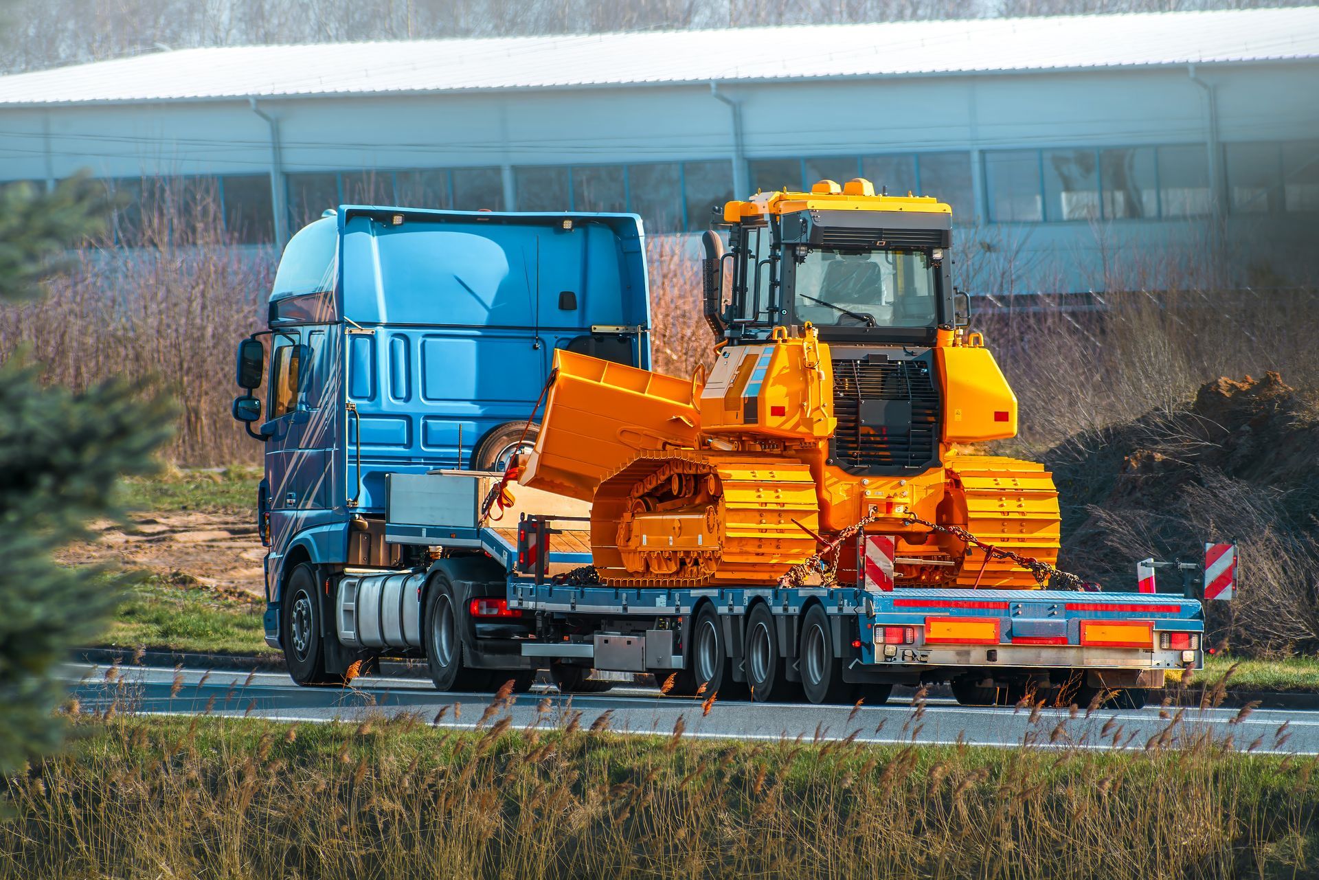 Tractor with shovel equipment on hauling truck.