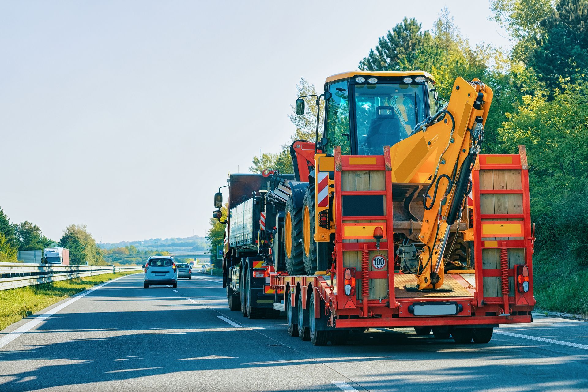 Truck trailer transporter with hauler carrying tractor.