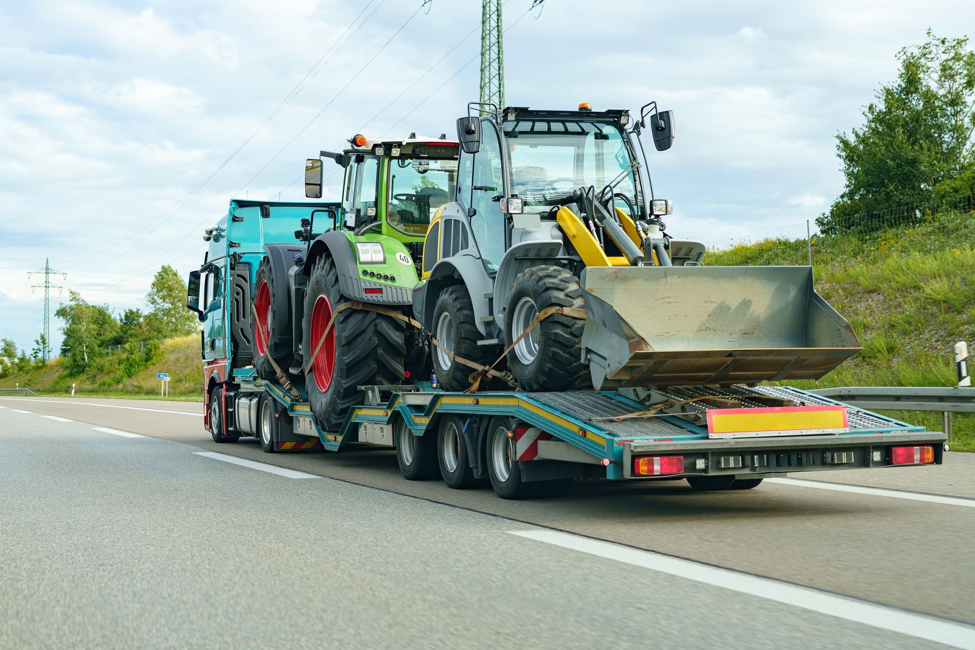 Tractor on a tow truck for transportation by road.