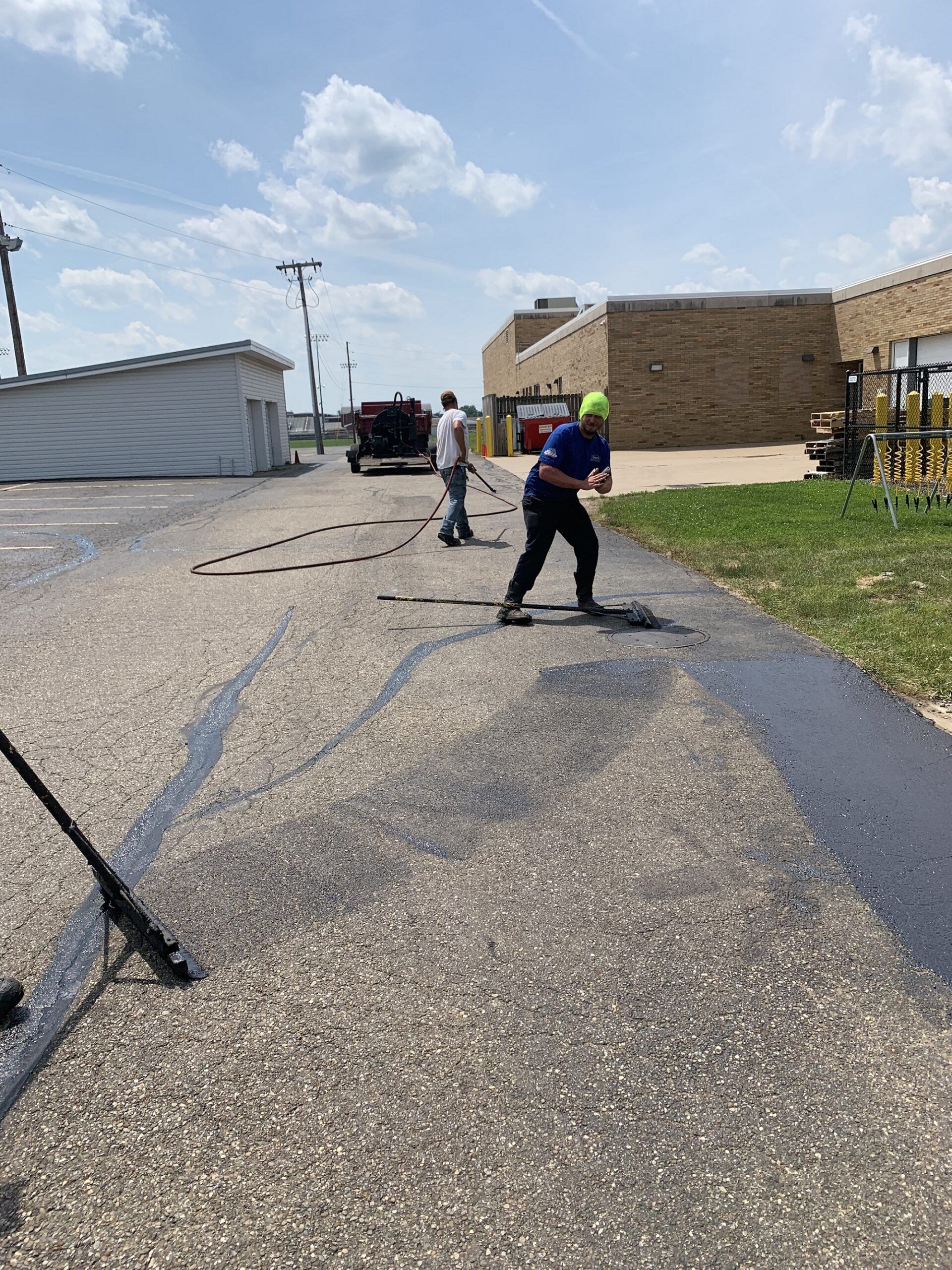 Workers Stripping on Road — Canton, OH — Milhoan Asphalt Maintenance Inc