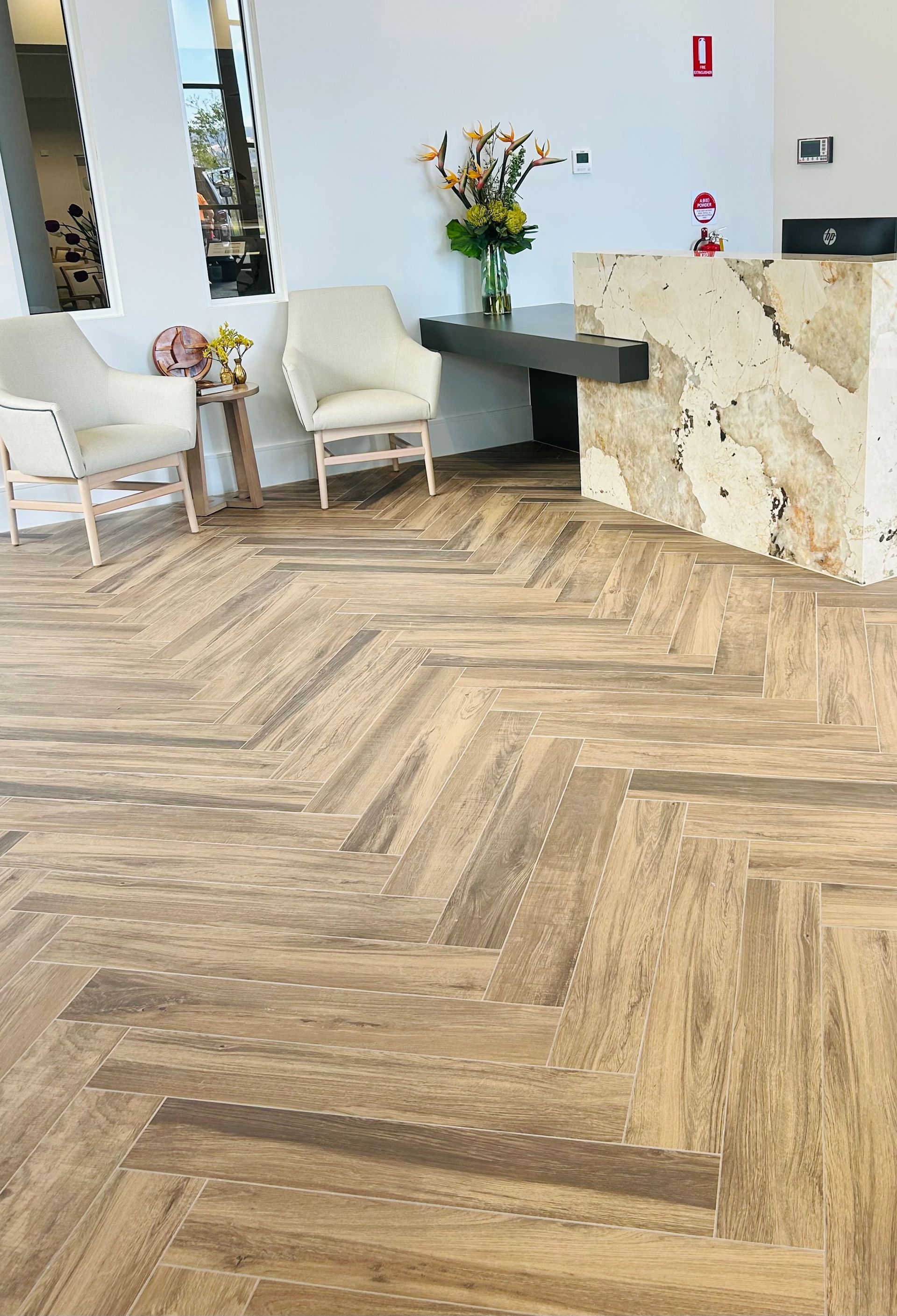 A Bright, Modern Lobby With a Herringbone-patterned Floor — Hobart Tiling Solutions In Clarendon Vale, TAS