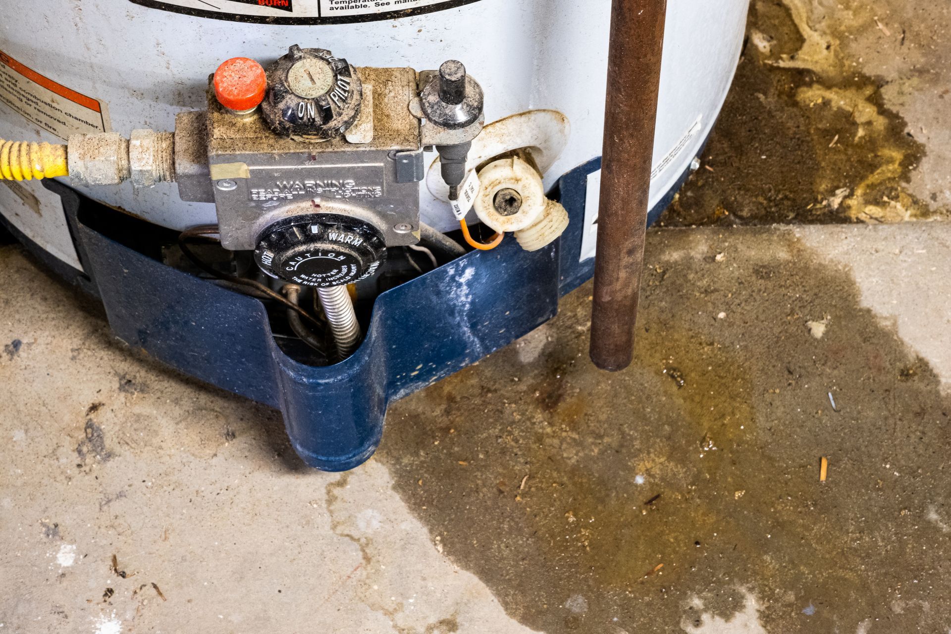Close up of an old leaking water heater that needs replaced