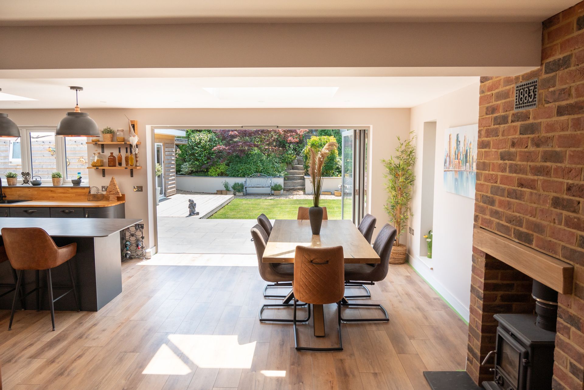 A dining room with a table and chairs and a fireplace.