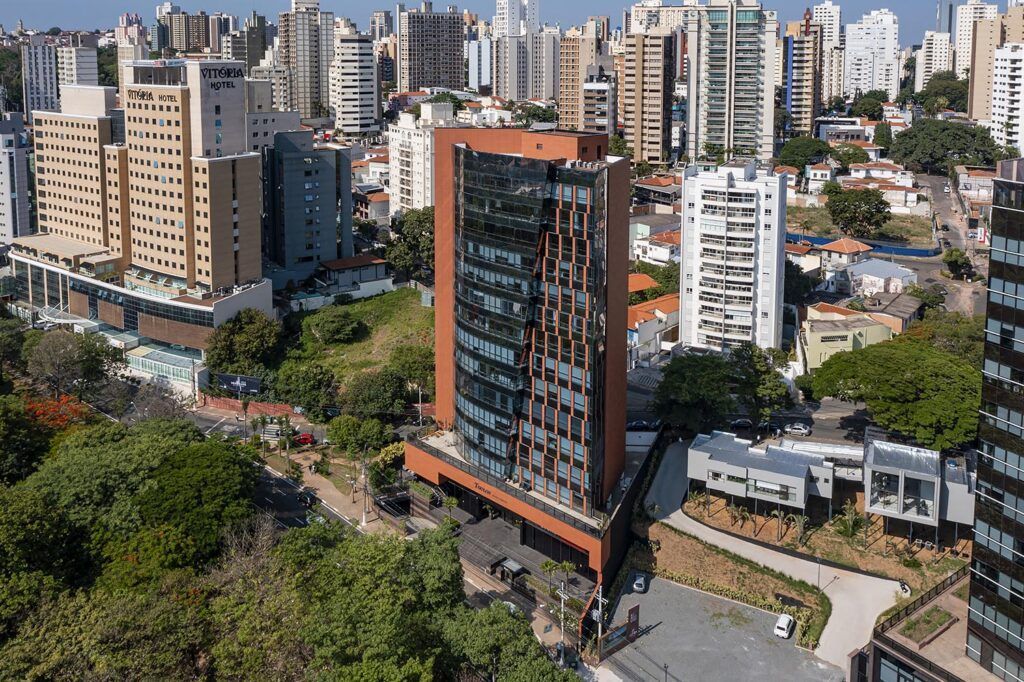An aerial view of a city with a large building in the middle.