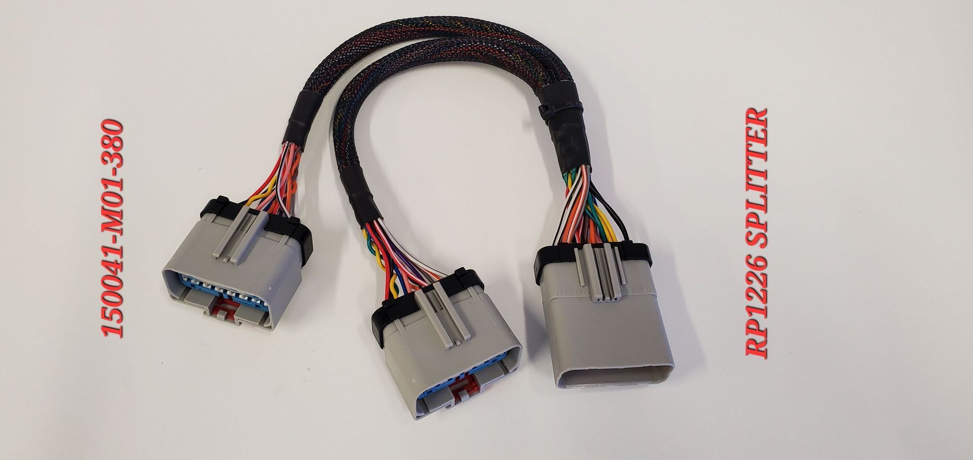 A couple of wires are connected to each other on a white surface.