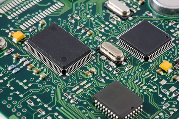 A close up of a motherboard with a lot of chips on it