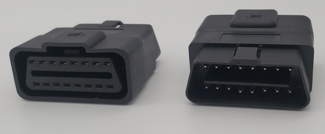 Two black car diagnostic OBD-II connectors, front and angled views on a light background