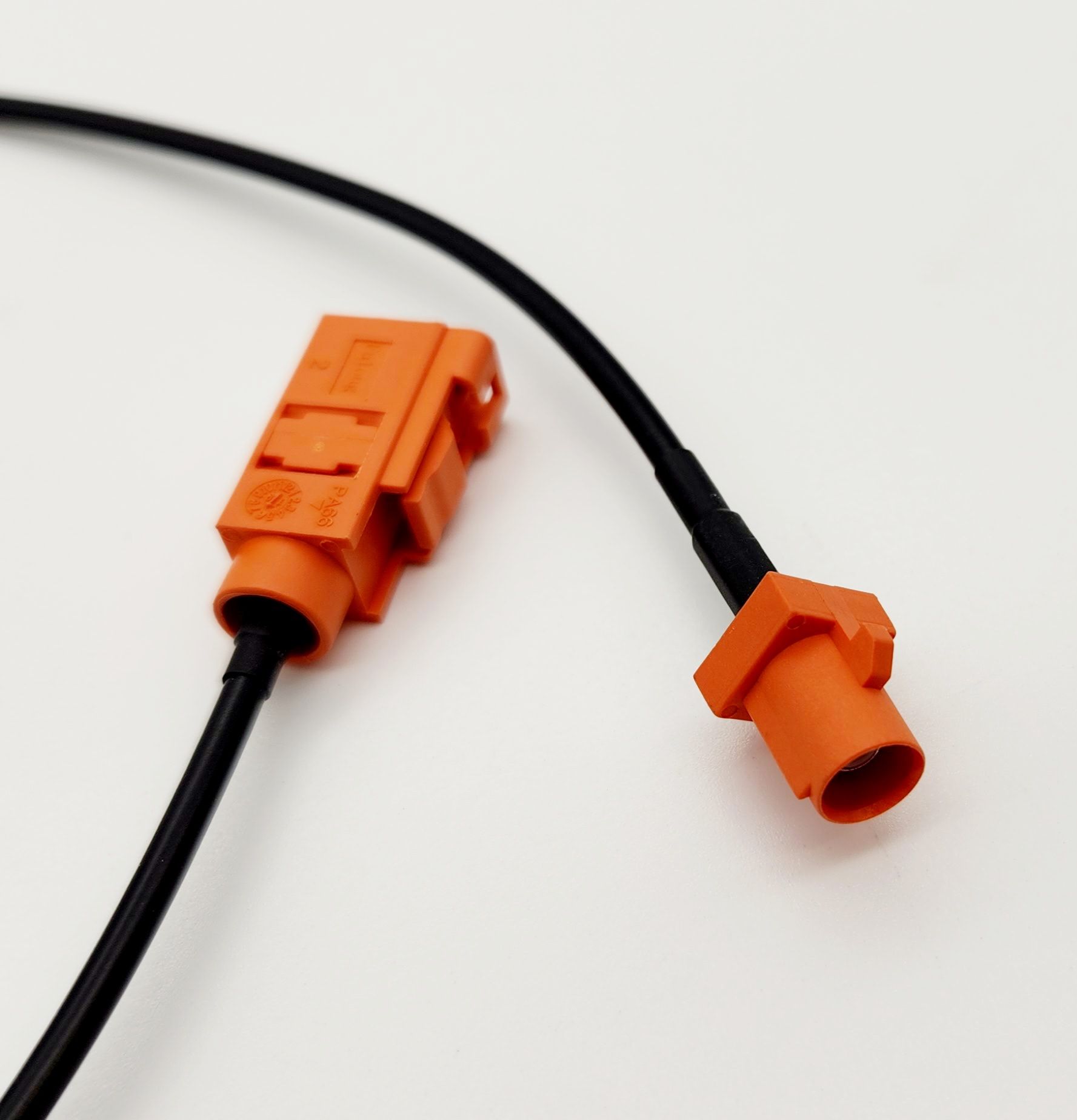 A close up of an orange connector on a black cable