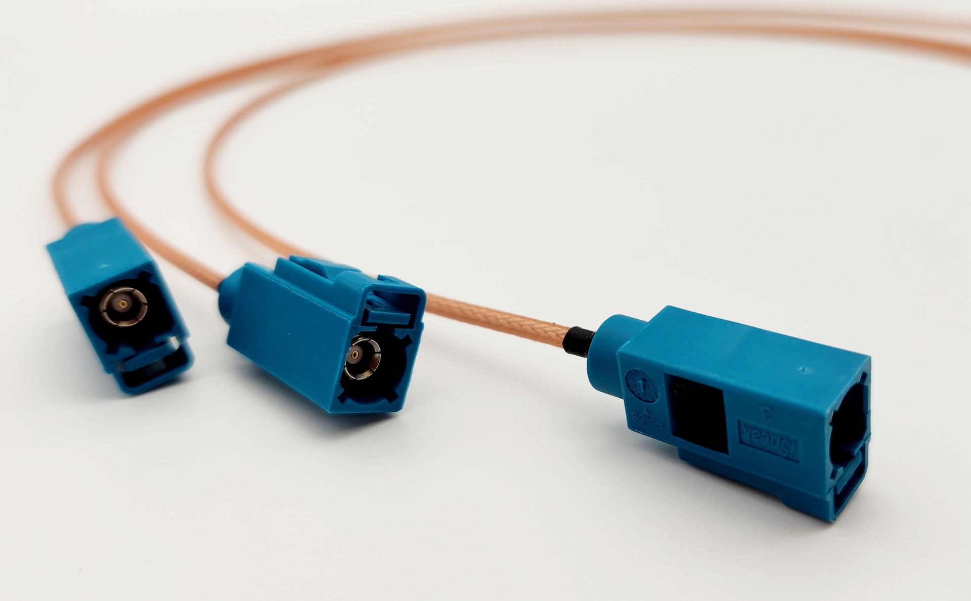 A close up of three blue connectors on a wire