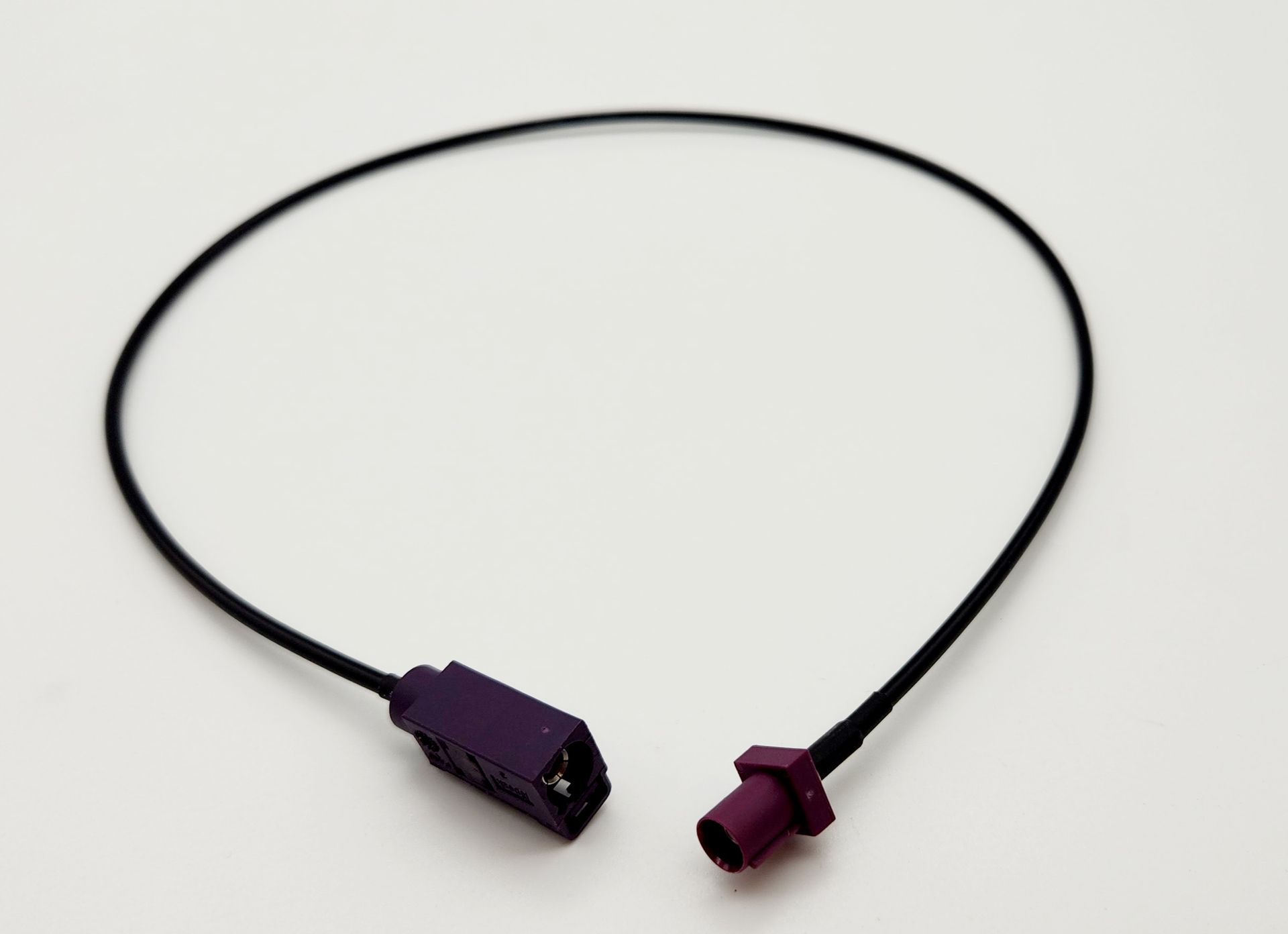 A black cable with a purple plug on the end