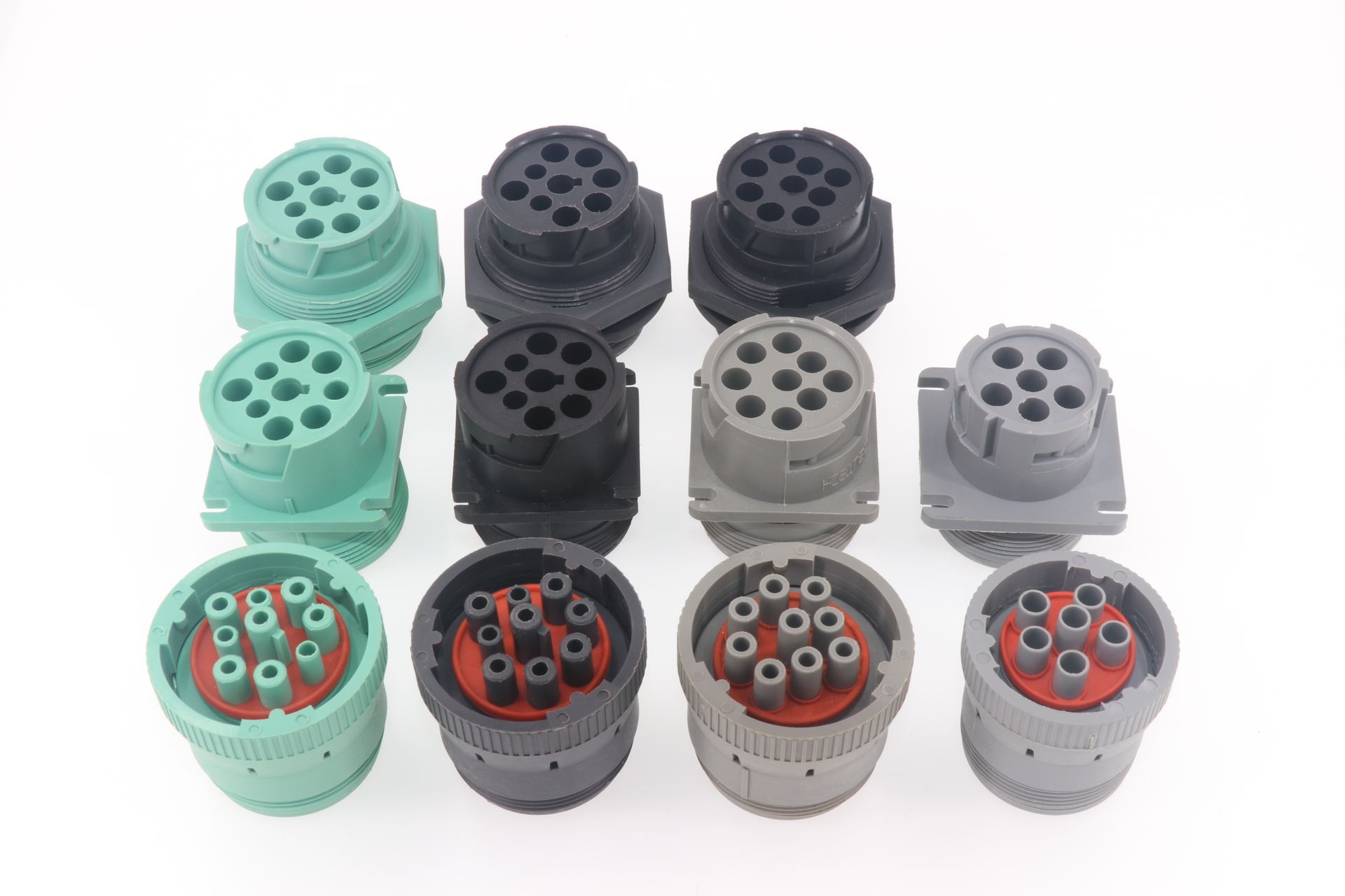 A bunch of different colored connectors are sitting on top of each other on a white surface.