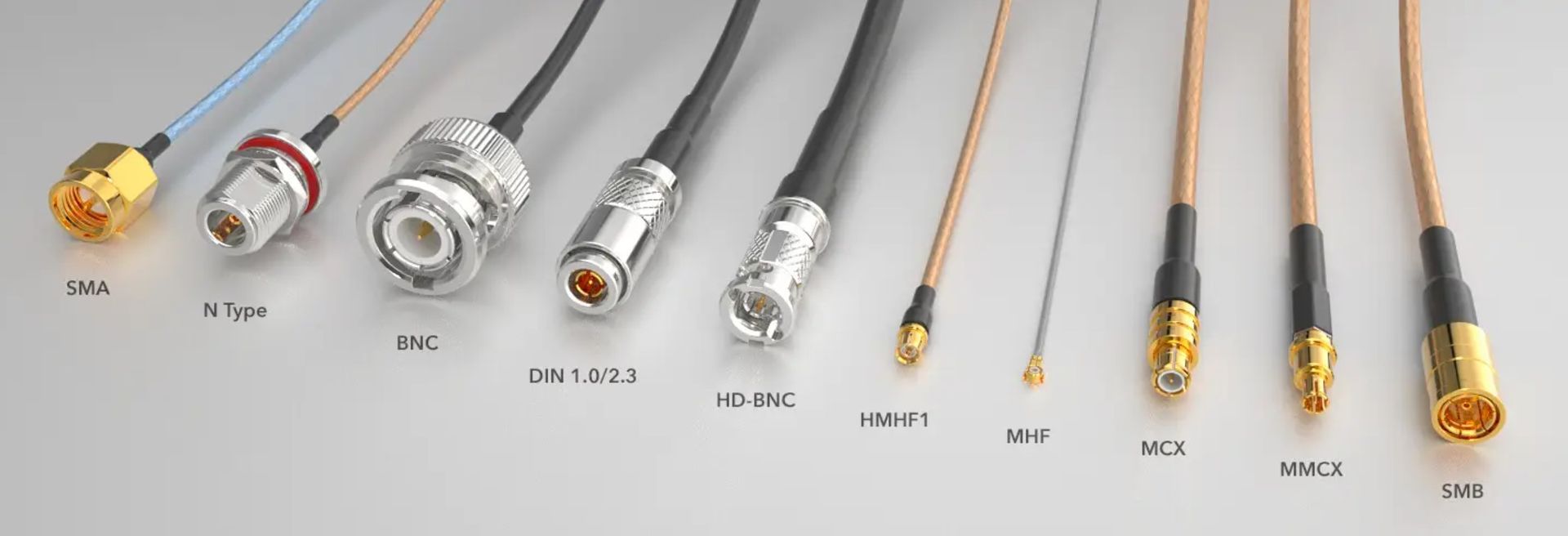 A bunch of different types of cables are lined up on a table.