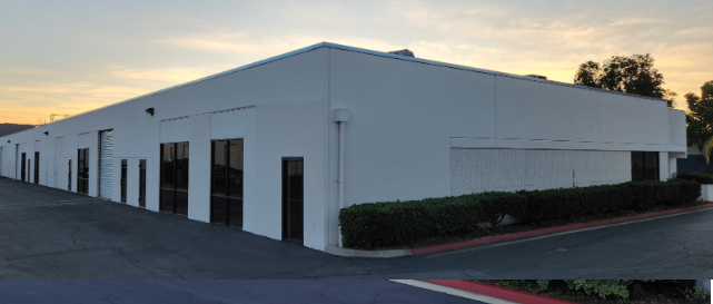 A large white building with a lot of windows and doors.