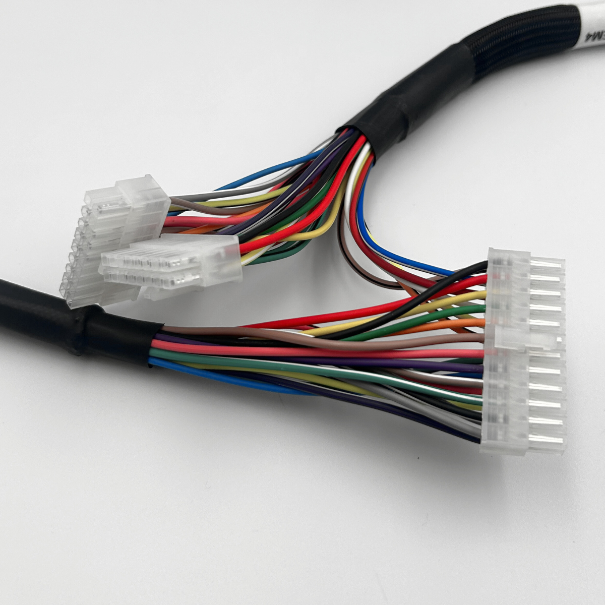 Colored wire harness connectors with bundled multicolored cables on a white background
