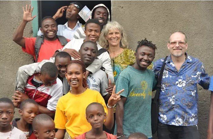 A group of people posing for a picture with one man wearing a shirt that says liberty
