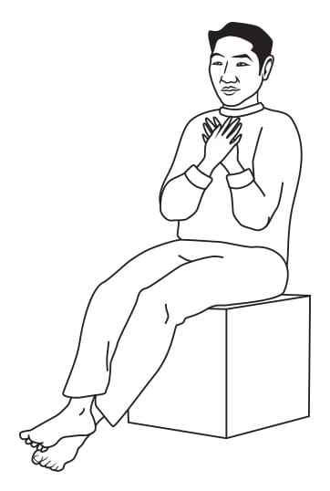 A black and white drawing of a man sitting on a box with his hands on his chest.