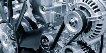 A close up of a car engine with a belt.