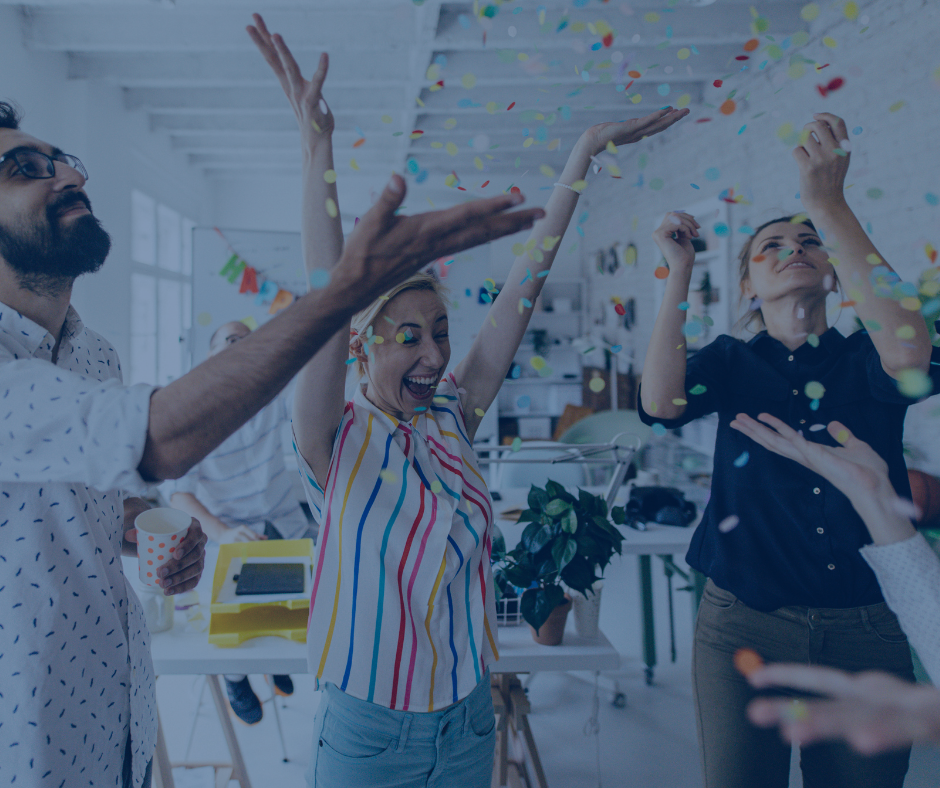 A group of people are throwing confetti in the air at a party.