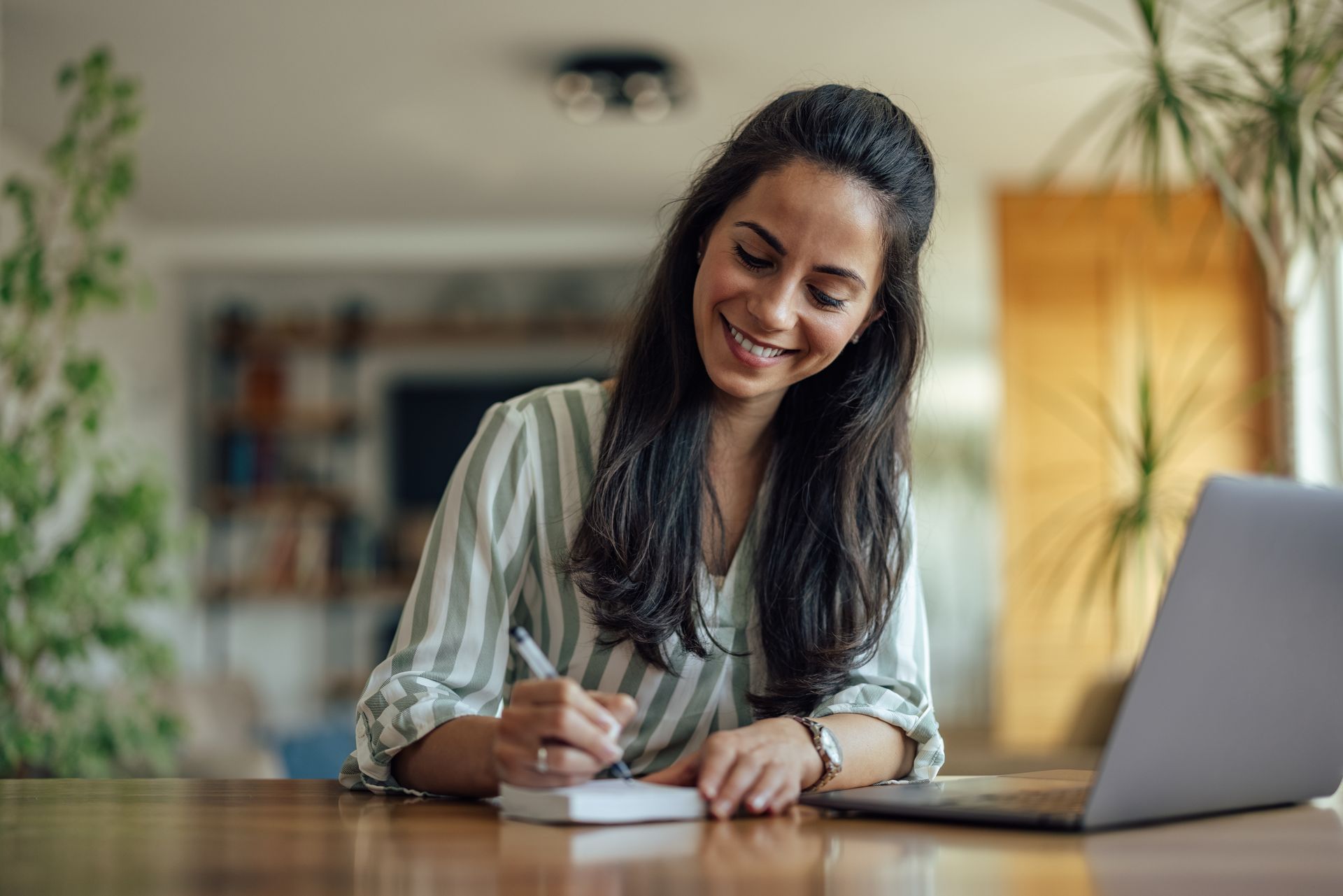 A hopeful adult woman in her living room, getting ready to get a loan.