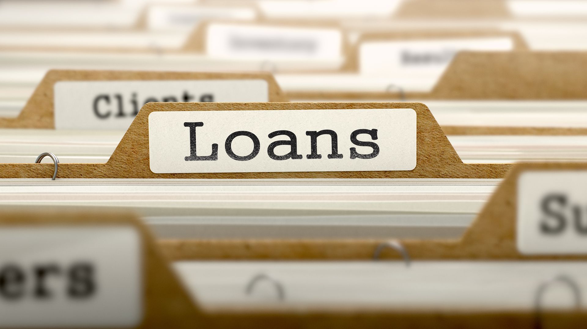 Loans concept with word on folder.