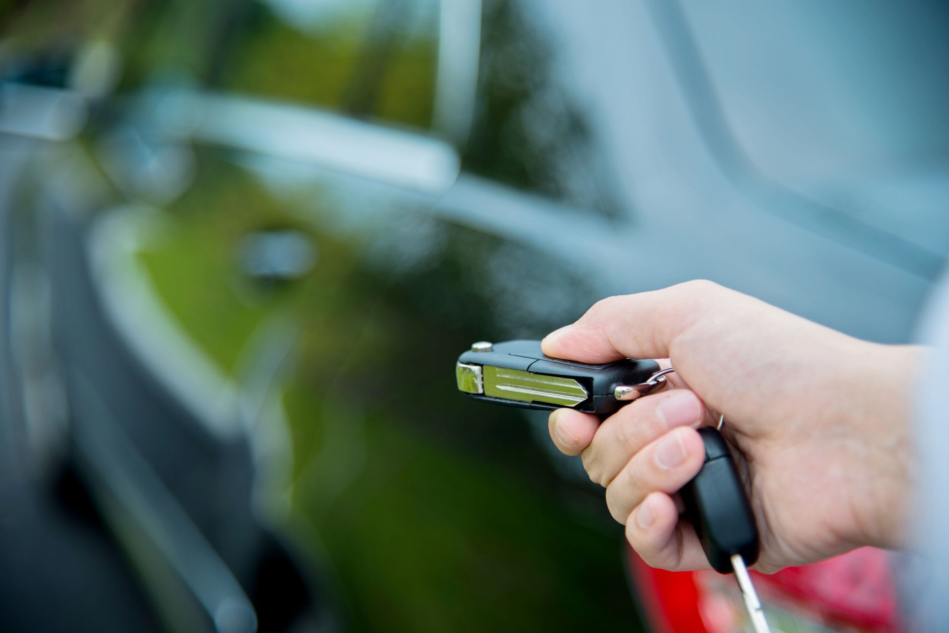 Unlocking a car with a key fob, showing the benefits of securing an auto loan in Gonzales, LA.