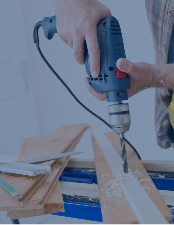A person is drilling a hole in a piece of wood