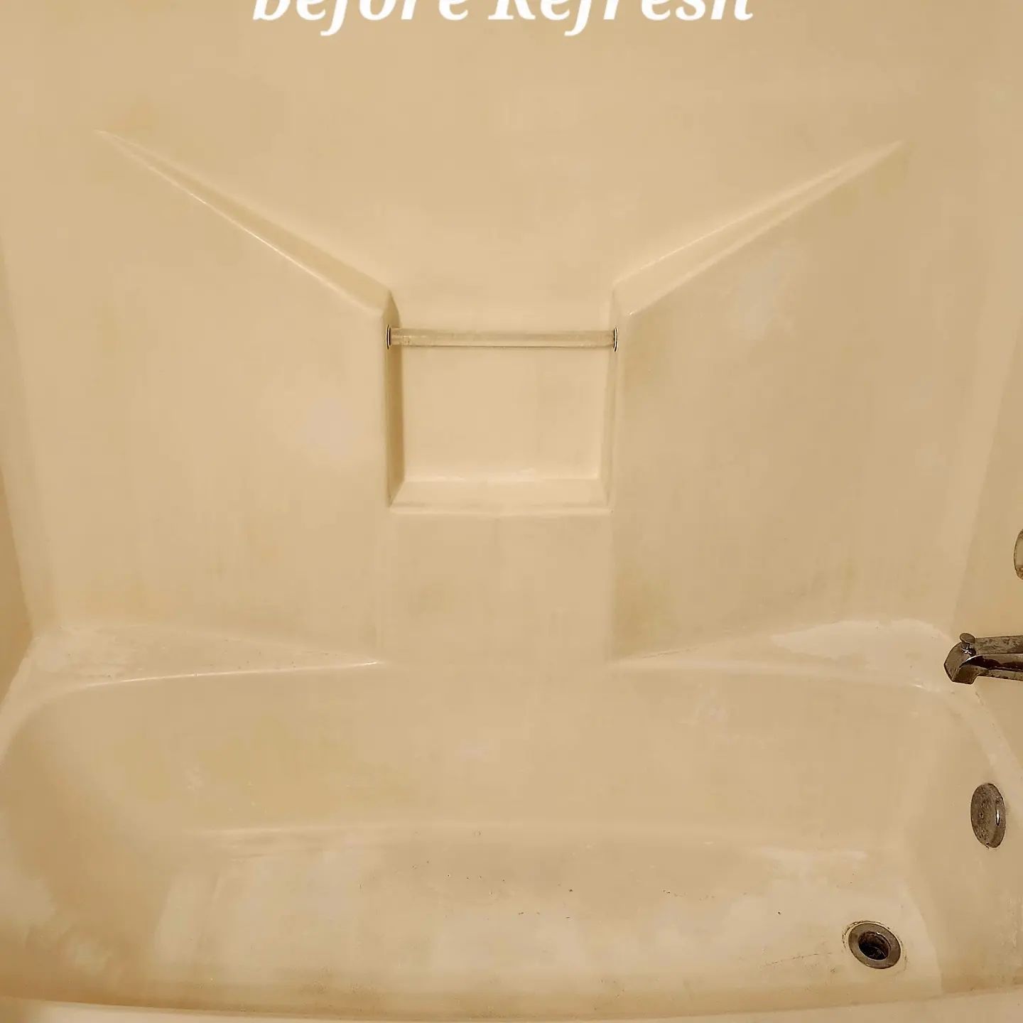 Stained beige bathtub before refresh, showing built-in backrest and soap dish.