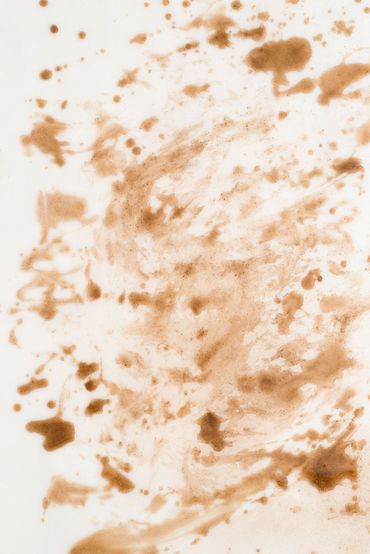 Brown coffee stains and splatters on a white background