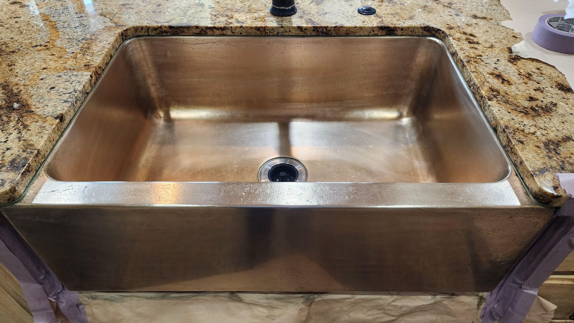 Stainless steel kitchen sink installed in a countertop with a single drain.