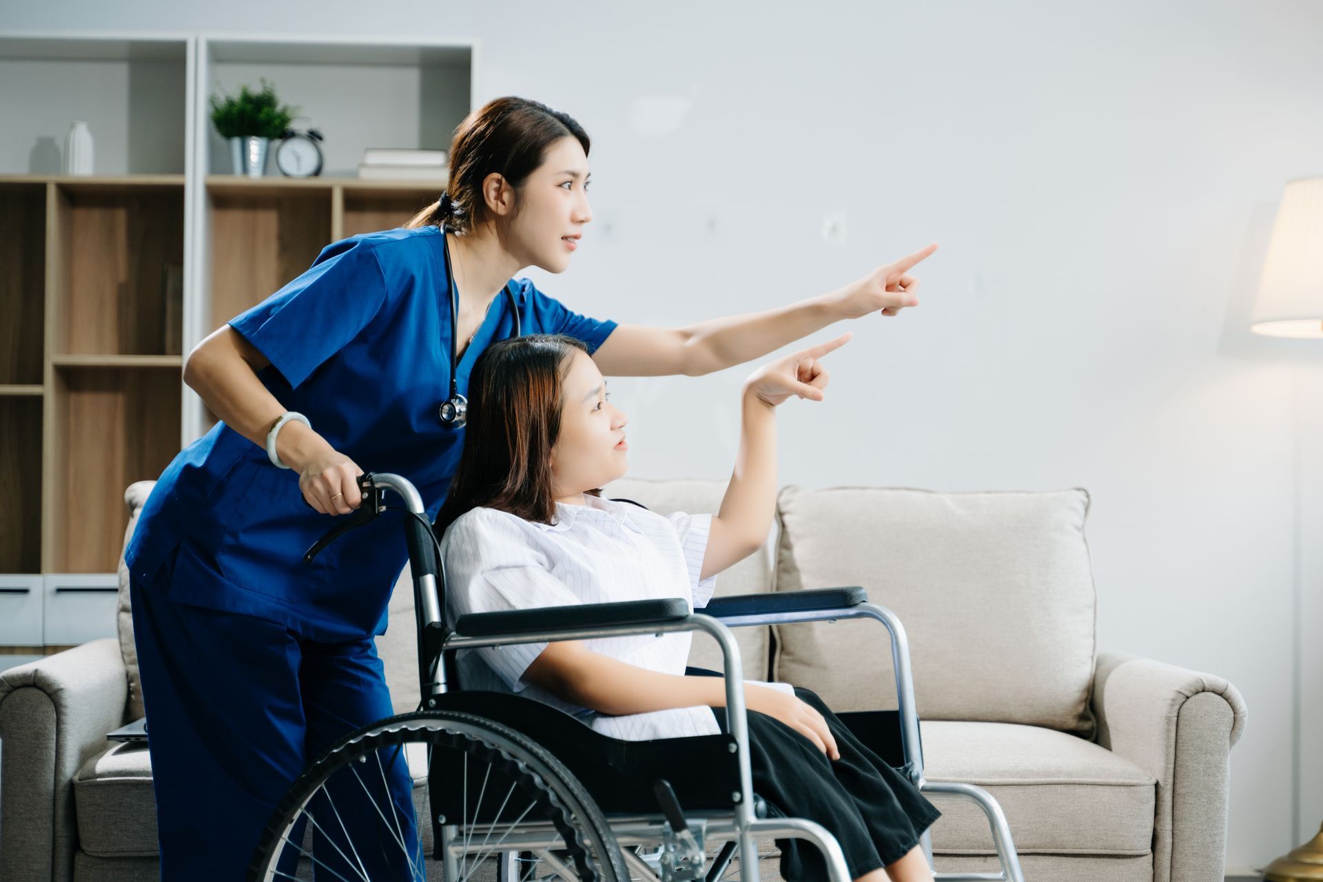 nurse pushing child in wheelchair