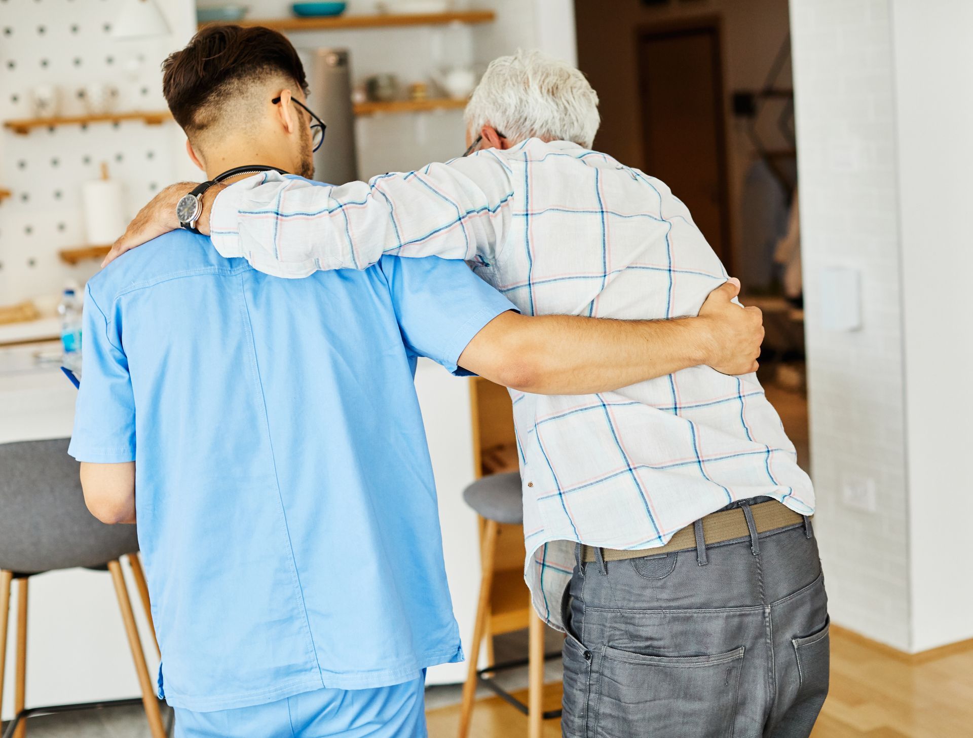 nurse helping elderly man walk 