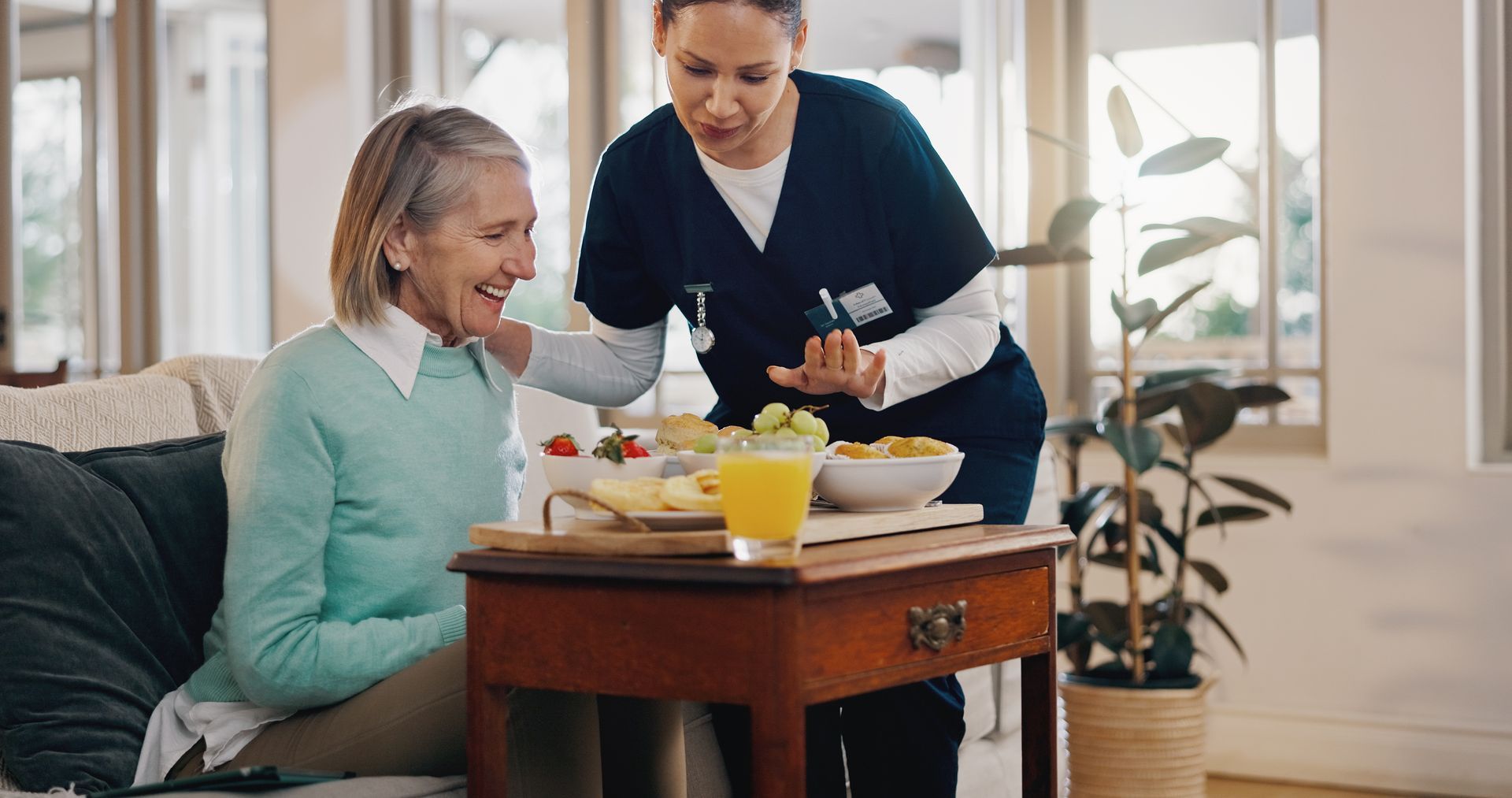 nurse serving old lady breakfast