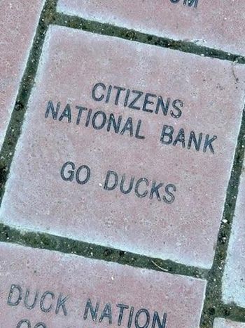 Brick walkway engraved βCITIZENS NATIONAL BANK GO DUCKSβ and βDUCK NATIONβ at the bottom edge
