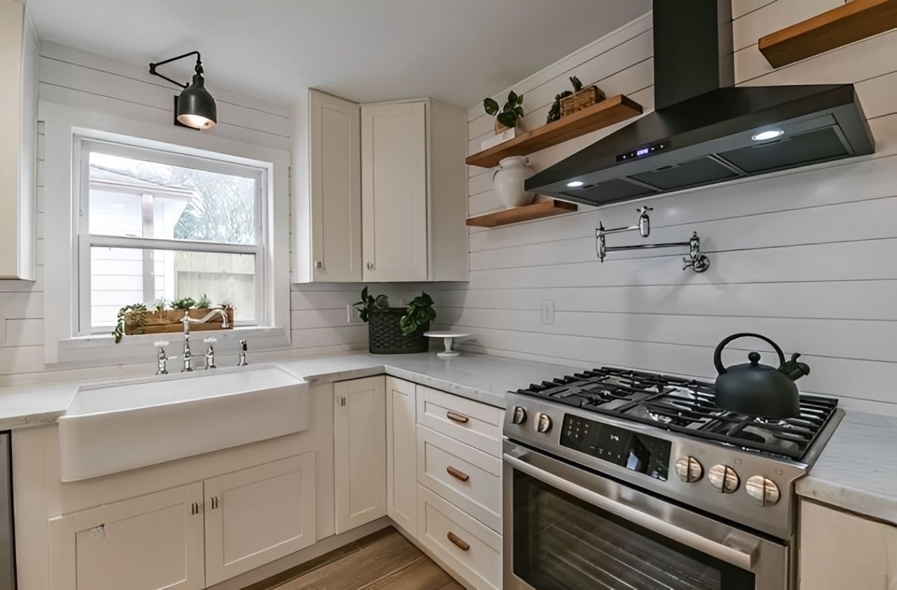 Bright modern kitchen with a large island, white cabinets, and bar stools