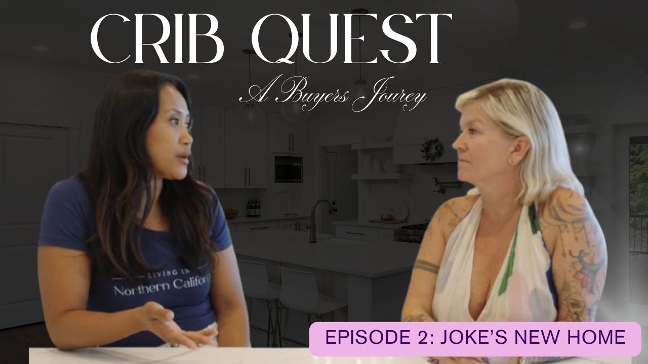 Two women in a kitchen, one gesturing while speaking.