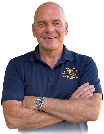 Smiling bald man in navy polo with crossed arms, wearing a wristwatch, on a white background