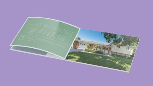 A book is open to a page with a picture of a house on it.