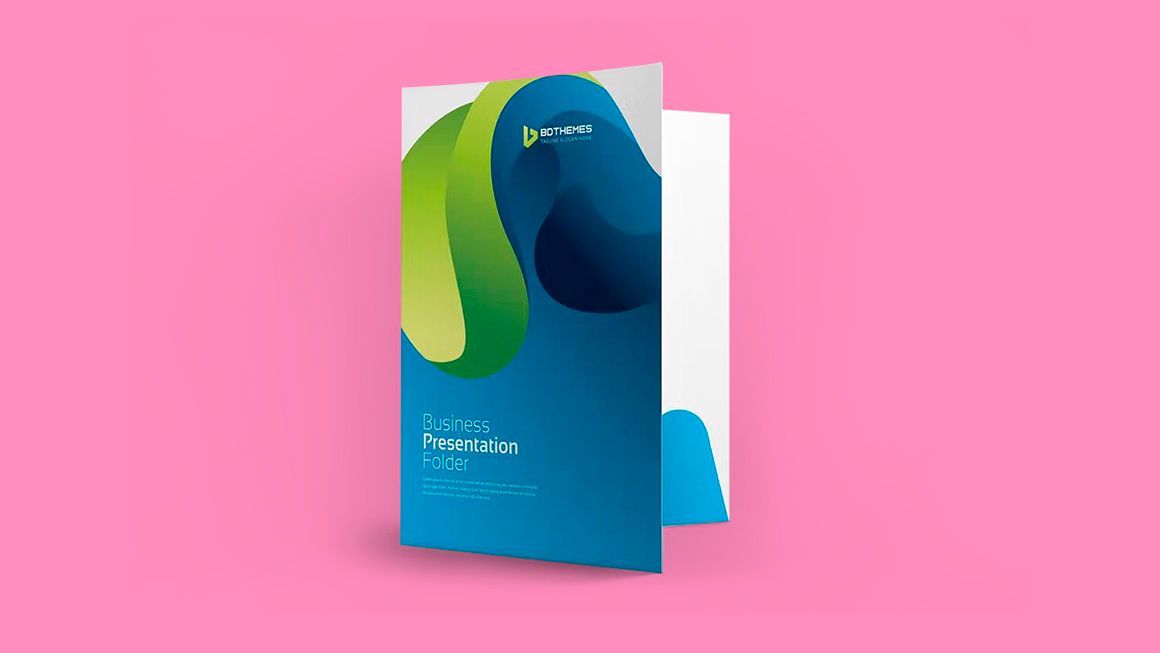 A blue folder with a green swirl on it is sitting on a pink surface.