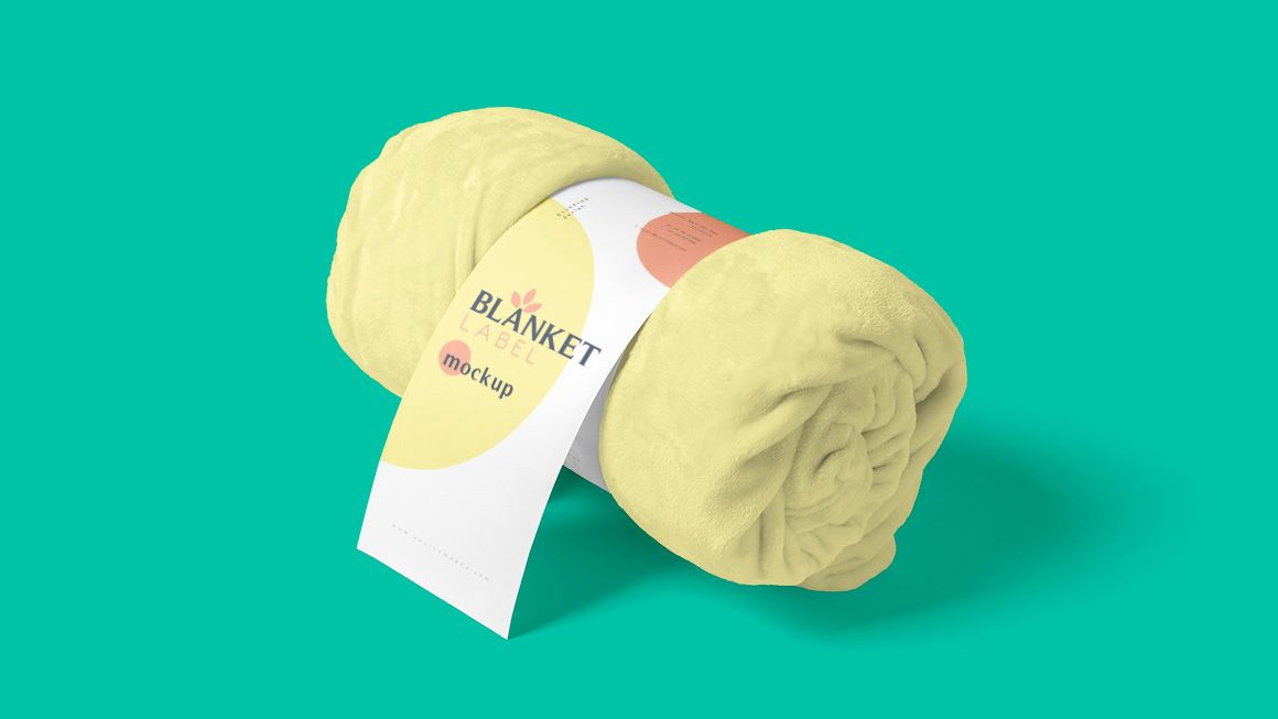 A roll of yellow blanket with a label on it on a green background.