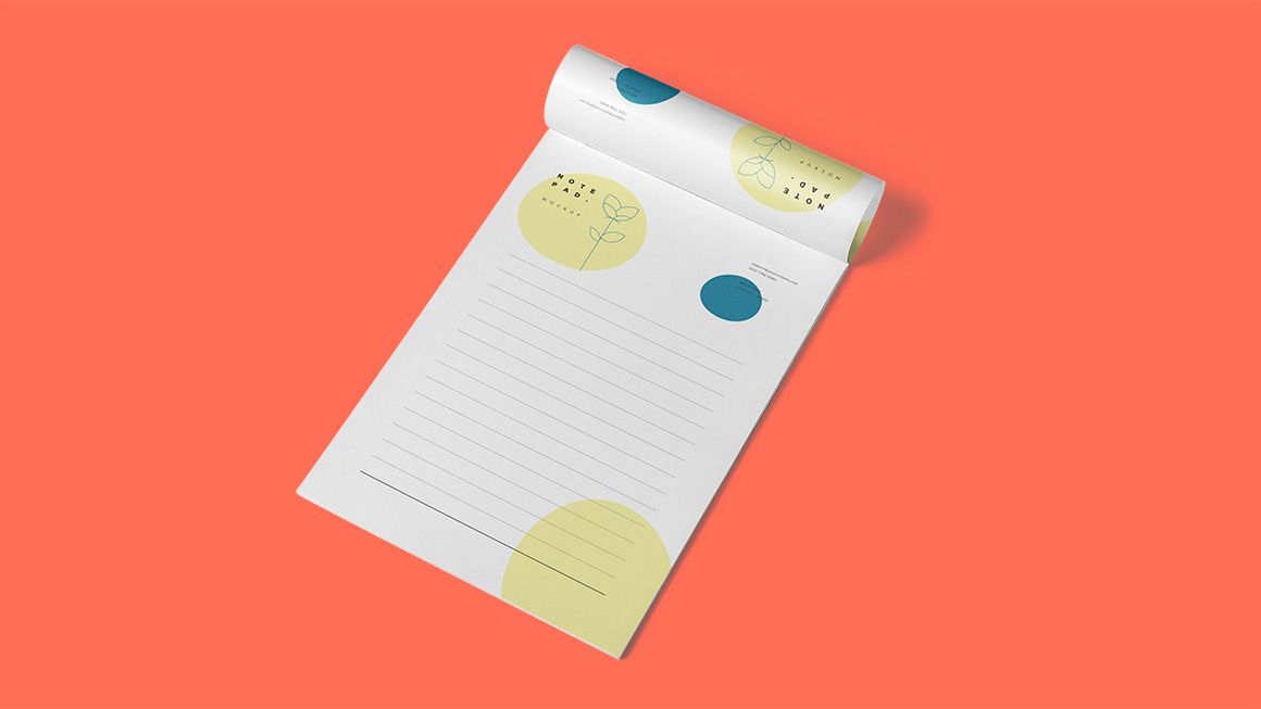 A notepad with circles on it is sitting on a red surface.