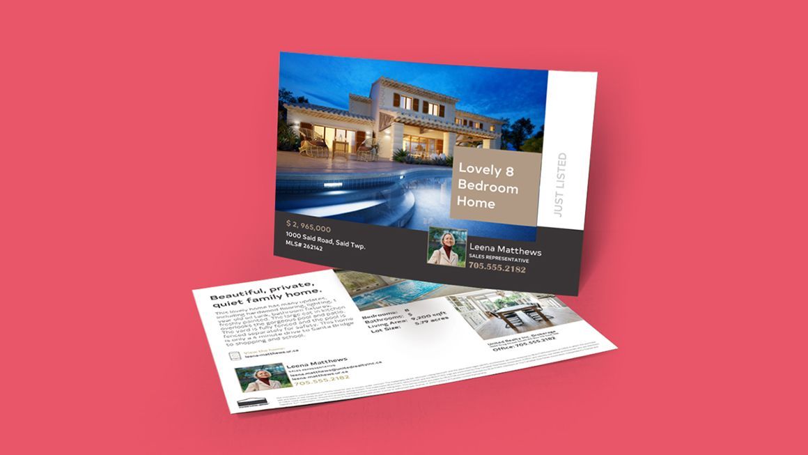 A postcard with a picture of a house on it is sitting on top of a pink table.