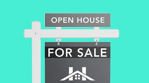 An open house for sale sign is hanging from a pole.