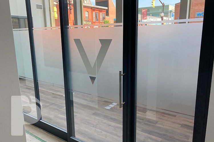 A sliding glass door with a logo on it.