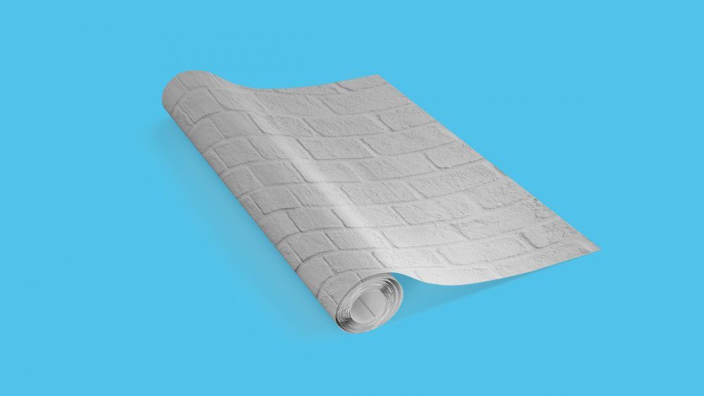A piece of paper is rolled up on a blue surface.