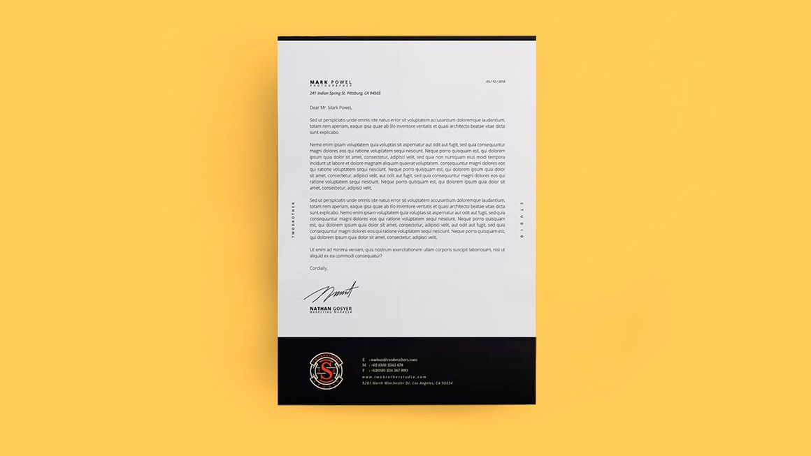 A letter is sitting on a yellow surface.