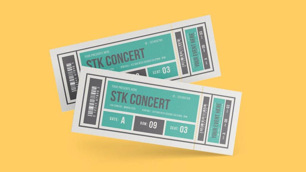 Two concert tickets are sitting on top of each other on a yellow background.