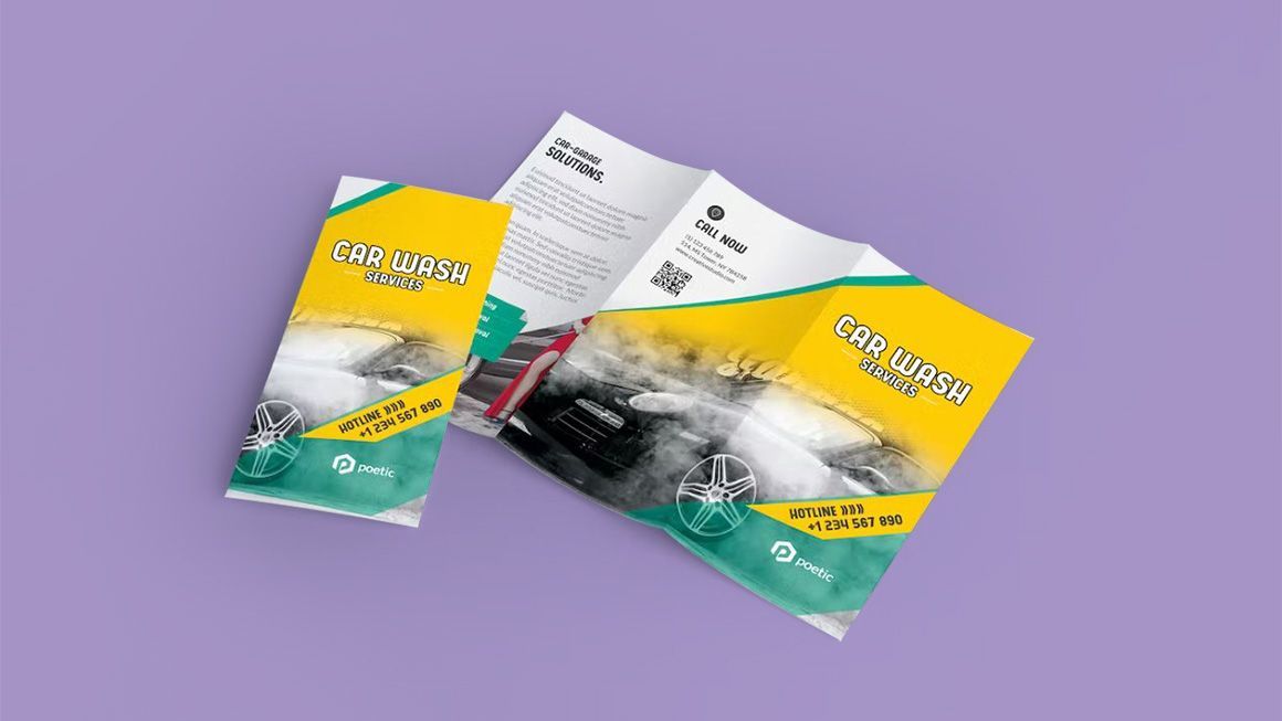 Two brochures are sitting on top of each other on a purple surface.