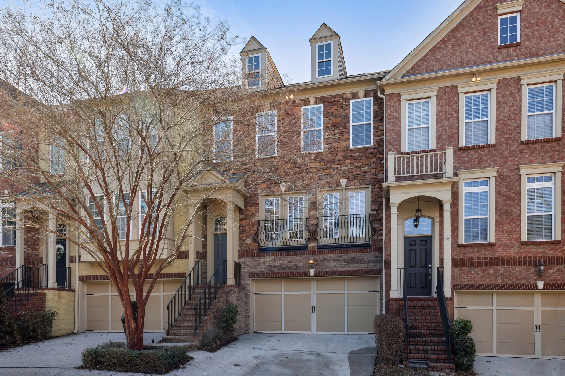Townhouses with brick exteriors and attached garages.
