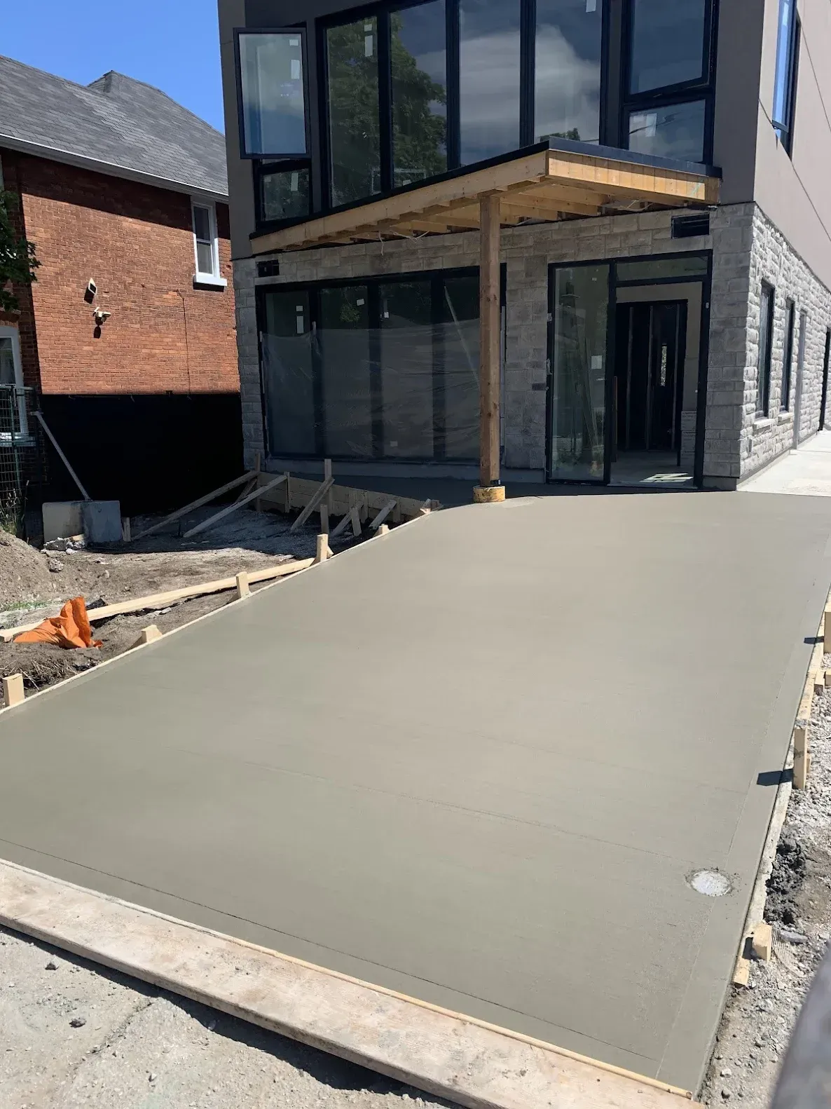 A concrete driveway is being built in front of a building.