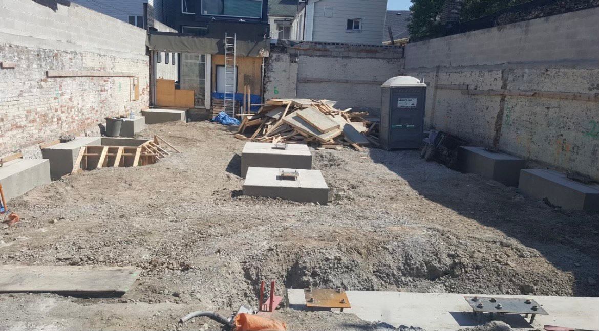 A construction site with a lot of dirt and concrete.
